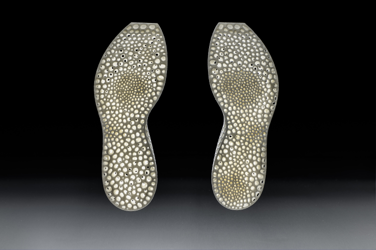 The midsole on the left is generated from the underfoot pressure data of a person who runs with a midfoot strike and the right midsole is generated from heel strike data.  